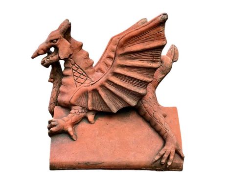 A terracotta 'Brecon Dragon' ridge tile. Height 35cm, width 36cm.