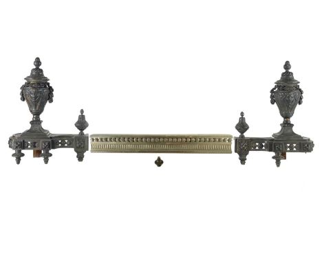 A pair of French bronzed Chenet and fender rail. 19th century, with classical urn mounts and pierced and cast ornament, heigh
