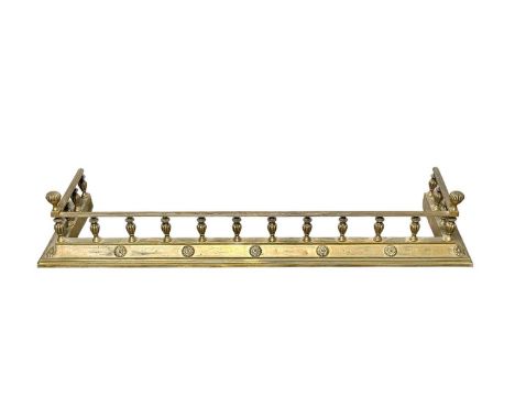 A late Victorian brass fender. With a reeded gallery, the base set with patarae and neatly engraved with dove motifs, width 1