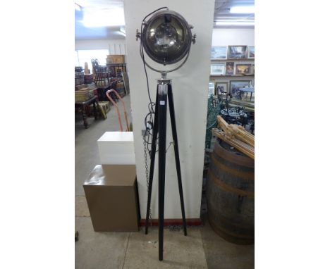 A chrome theatre style spotlight on a tripod base