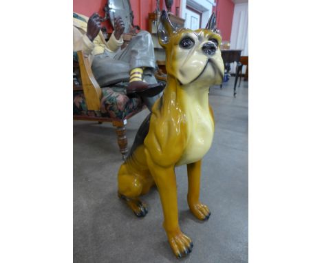 A large ceramic figure of a boxer dog