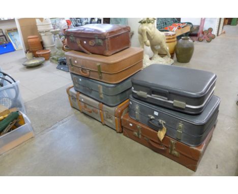 A banded trunk and six suitcases