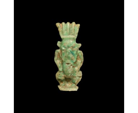 Third Intermediate Period, 1069-702 BC. A green glazed composition figure of Bes sanding nude on a rectangular base, wearing 