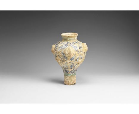 11th century AD. A fragmentary ceramic vase with applied gold leaf decoration, blue wave pattern to the background, large bos