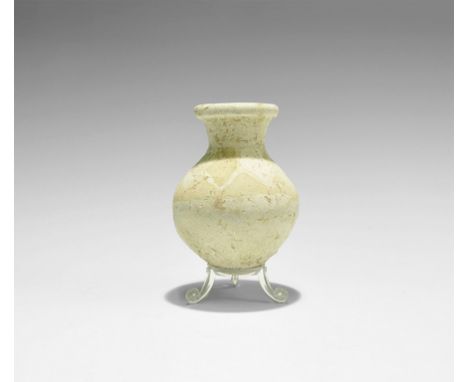 1st millennium BC. A ceramic jar with slightly conical underside, funicular neck and rounded rim; cream pigment to the should