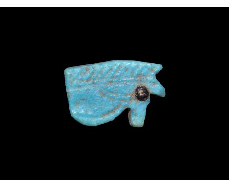 Third Intermediate Period, 1069-702 BC. A blue glazed composition wedjat with incised brow detailing, black pigment to the pu