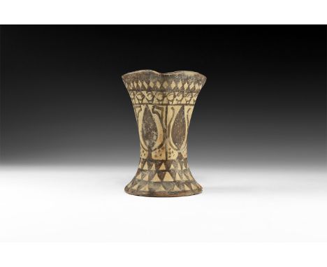 3rd-2nd millennium BC. A ceramic cup with flared discoid base rising to an irregular rectangular-section mouth; bands of pain