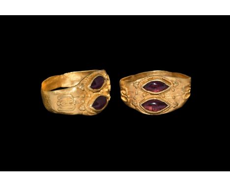 Later 7th century AD. A gold finger ring comprising a flat-section hoop with applied granule omega-shaped detail to each shou