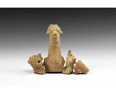 2nd-1st millennium BC. A mixed group of four ceramic items comprising of: a curved handle or a vessel spout formed as a ram h