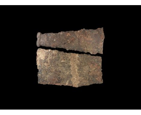 3rd-1st century BC. An iron sword blade fragment tapering to a transverse scabbard foot, remains of mineralised wood to one f