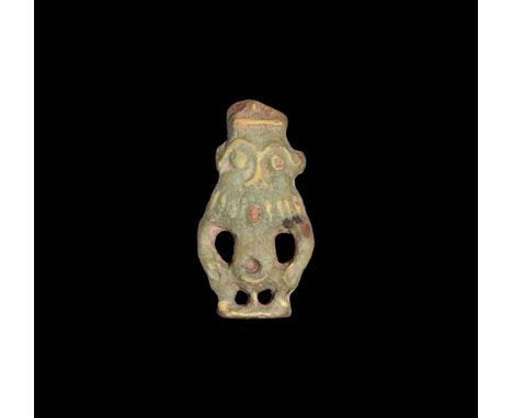 Third Intermediate Period, 1069-702 BC. A large olive-green glazed composition bifacial amulet of Bes with applied yellow det