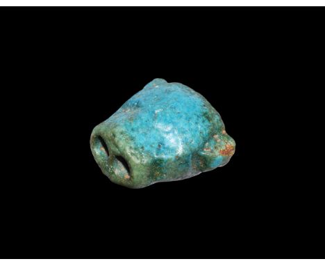 18th Dynasty, 1550-1292 BC. A green glazed composition amulet of a panther head, with twin tubular construction. Cf. Andrews,