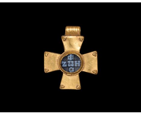 5th-7th century AD. A hollow-formed gold equal-arm cross pendant with granule cluster to the corners of each arm, tubular rib