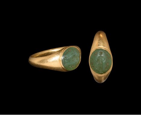 1st-2nd century AD. A gold finger ring comprising an elliptical-section hoop with expanding shoulders, round cell with inset 