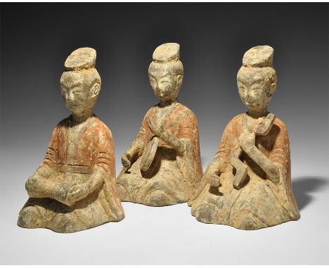 Han Dynasty, 206 BC-220 AD. A group of three ceramic tomb figures representing female musicians; each is shown kneeling and w