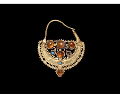 6th-7th century AD. A gold plaque earring comprising a suspension wire and coiled catch, crescentic plaque with panels of ope