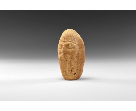 8th-6th century BC. A hollow ceramic head of a male with long beard and hair, large nose and almond-shaped eyes.  81 grams, 8