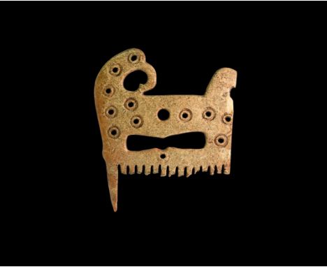 10th-12th century AD. A section of a finely made bone comb with finial formed as a coiled bird(?) head, concentric circles de