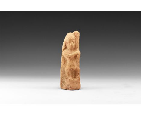 19th-17th century BC. A terracotta plaque with a high-relief figure of a standing musician holding an instrument over his lef