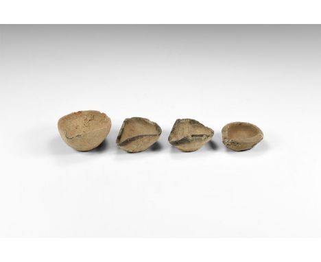2nd millennium BC. A group of four ceramic oil lamps with dished bodies and pinched wick end; flat base to each.  175 grams t