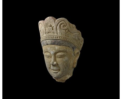 Ming Dynasty, 1368-1644 AD. A ceramic head of Kwan Yin with scrolled diadem; black, white, yellow and red pigment adhering.  