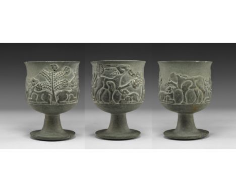 2nd millennium BC. A carved steatite chalice with discoid base and flared stem, frieze of animals, leaves and a tree with ena