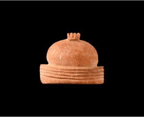Roman Period, 30 BC-323 AD. A red jasper carved amulet of a charm-case with ribbed base and loop, unpierced. Cf. Flinders Pet
