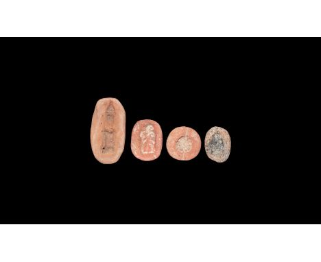 Mainly Late Period, 664-332 BC. A mixed group of ceramic moulds for amulets comprising: a rosette, an advancing figure with s
