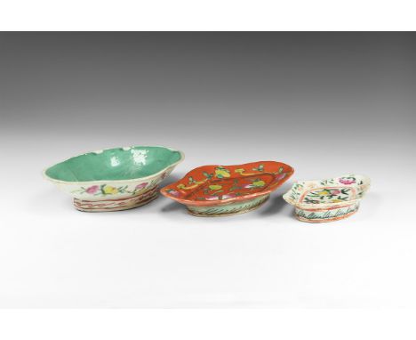 19th century AD. A mixed group of three glazed ceramic footed dishes with polychrome fruit and flowers motifs.  600 grams tot
