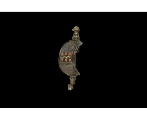 2nd century AD. A bronze bridge-type plate brooch with D-section balustered finials, central rectangular panel with polychrom