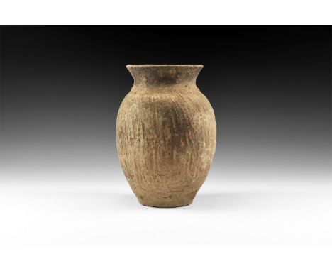 Neolithic Period, 3rd millennium BC. A biconvex ceramic jar with flared rim, ridged leather texture to the body and shoulder.