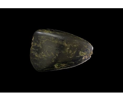 Neolithic, 6th-4th millennium BC. A ground and fully polished axe in a dark green mottled hardstone, sub-triangular in form w