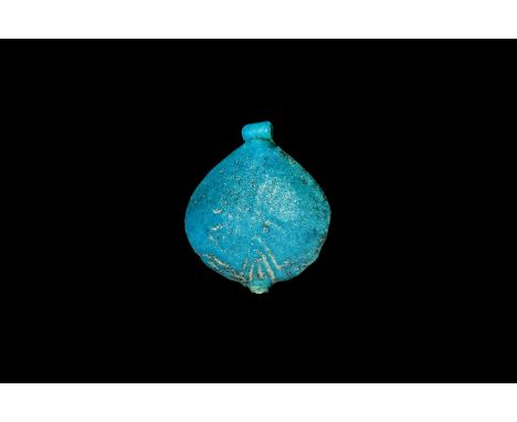 Amarna Period, 1353-1336 BC. A blue glazed composition amuletic pendant of a mandrake fruit with loop at each end. Cf. Andrew