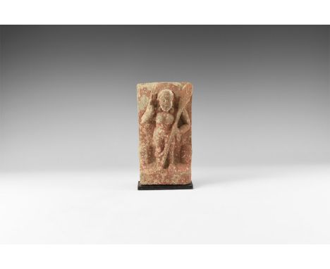 10th-12th century AD. A carved stone panel with ledge to the base supporting a facing female with right hand raised to the sh