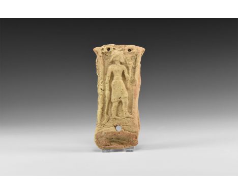 19th-18th century BC. A rectangular terracotta plaque with a low relief figure of a standing man wearing a short skirt and ha