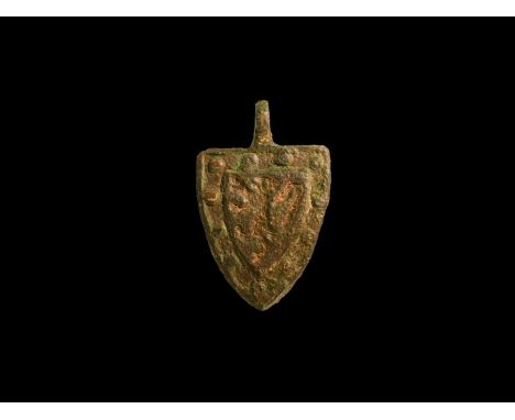 13th-14th century AD. A bronze heater-shaped harness pendant with pellets to the border and rampant lion, attributed to Richa