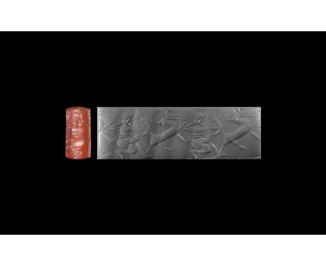 9th-7th century BC. A carnelian cylinder seal, a contemporary copy of an earlier seal, with intaglio frieze of a crouching bo