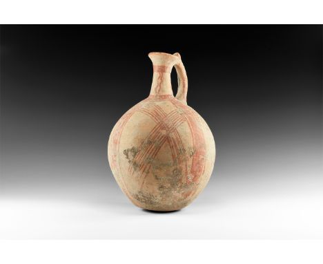 Iron Age, 12th-9th century BC. A bulbous ceramic vessel with flat base, tubular neck with flared rim, strap handle, red hatch