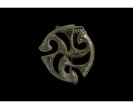 1st century AD. A bronze openwork plate brooch formed as radiating La Tène trumpet motifs; sprung pin and catch to the revers