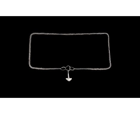 9th-11th century AD. A silver trichinopoly chain with three loops closure, the central loop with attached silver Thor's hamme
