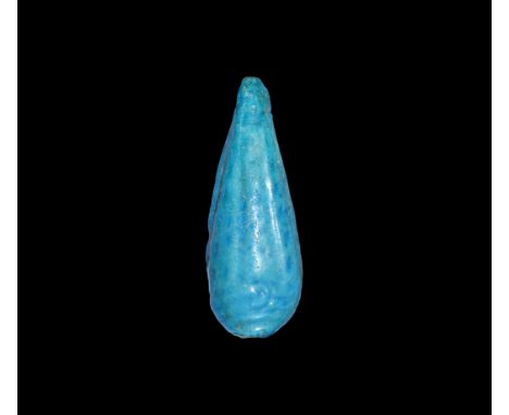 18th Dynasty, 1550-1292 BC. A bright blue glazed composition amulet of a palm leaf. Cf. Andrews, C. Amulets of Ancient Egypt,