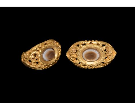 3rd century AD. A substantial D-section gold hoop with openwork leaf and tendril detailing, flat bezel with C-scrolls and cen