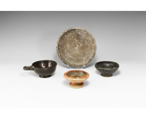 5th-3rd century BC. A mixed blackware ceramic group comprising: a footed dish; a kylix with flared foot, chamfered rim, singl
