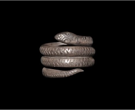 323-146 BC. A silver finger ring formed as a coiled serpent with scale detailing, lozengiform head with pellet eyes. Cf. Mars