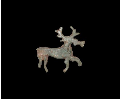 2nd century AD. A bronze plate brooch of an advancing stag with chamfered edges, pin-lug and fragment of catch to the reverse