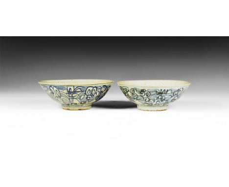 Ming Dynasty, 1368-1644 AD. A pair of broad glazed ceramic bowls with rolled rim and basal ring, pointillé initial to the inn
