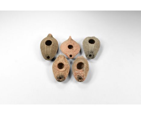 4th-5th century AD. A mixed group of ceramic slipper-shaped oil lamps with hatching to the outer face.  337 grams total, 9-10