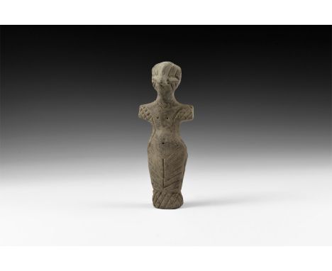 Neolithic, 6th-4th millennium BC. A large ceramic figurine of a standing male with prominent nose, stub arms extended, incise