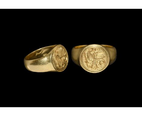 15th-16th century AD. A substantial D-section gold hoop with discoid bezel, bilinear incised border surrounding a regardant b