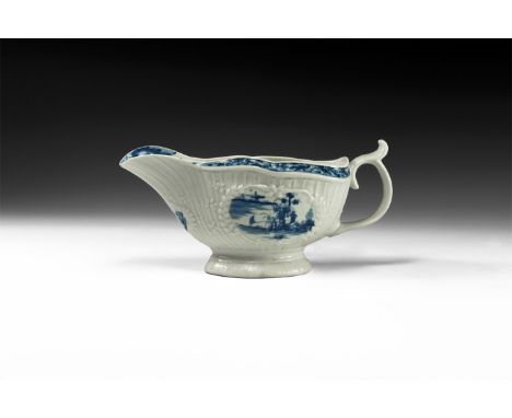 18th century AD. A tin-glazed ceramic gravy boat with blue oriental landscapes, tendril to the handle, foliage to the rim and